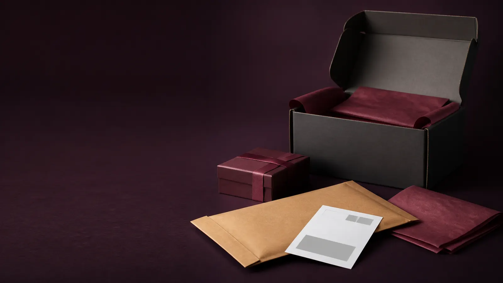 A plain unbranded parcel, kraft mailer, and sealed gift box arranged for discreet shipping.